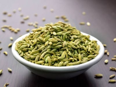 Fennel seeds in a bowl on a wooden table